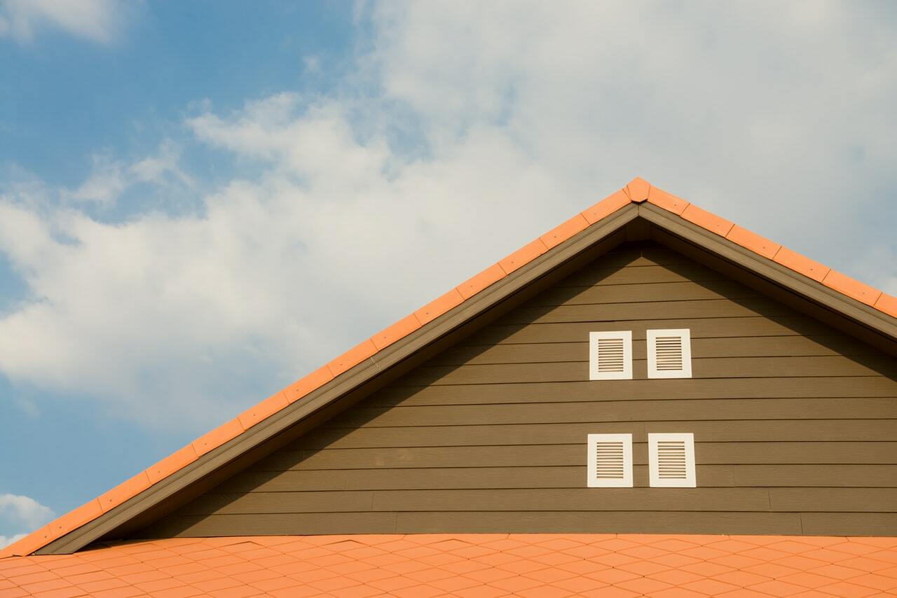 a wooden house with a red roof