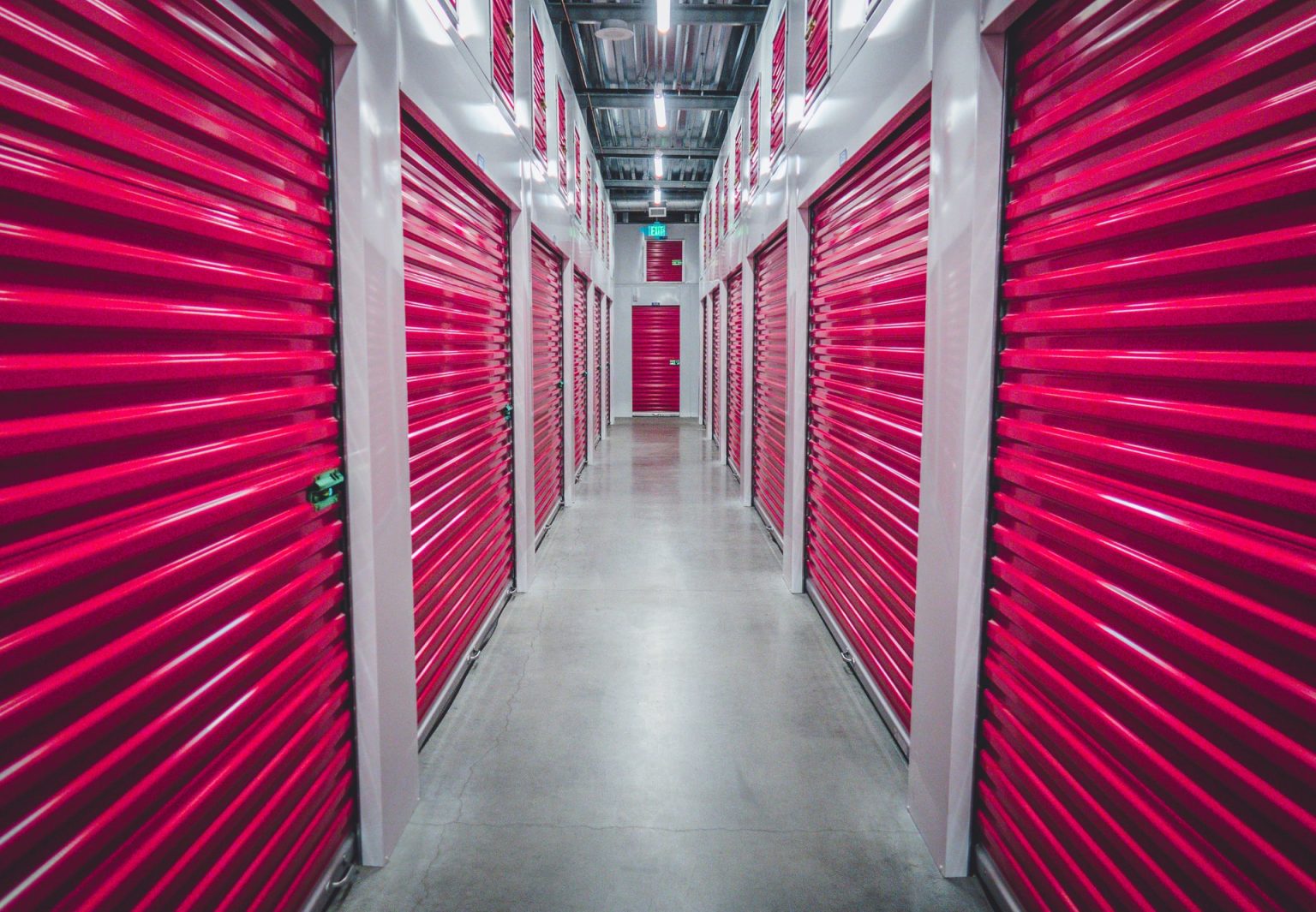 a hallway with red doors