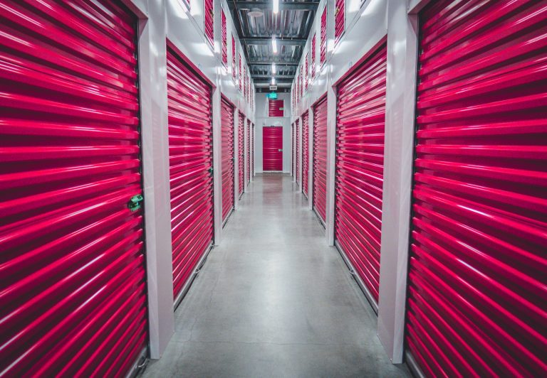 a hallway with red doors