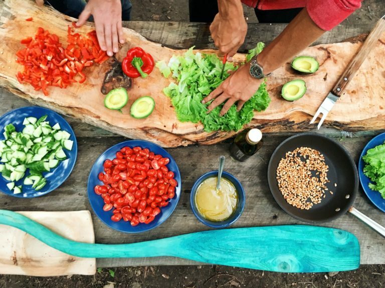 a person cutting vegetables on a cutting board