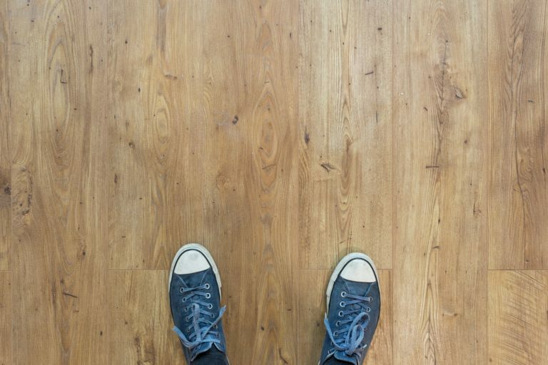 a pair of blue shoes on a wooden surface