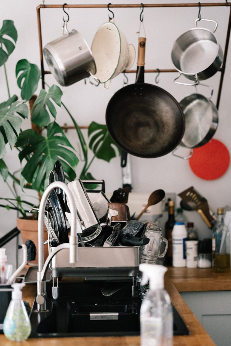 a kitchen with pots from the ceiling