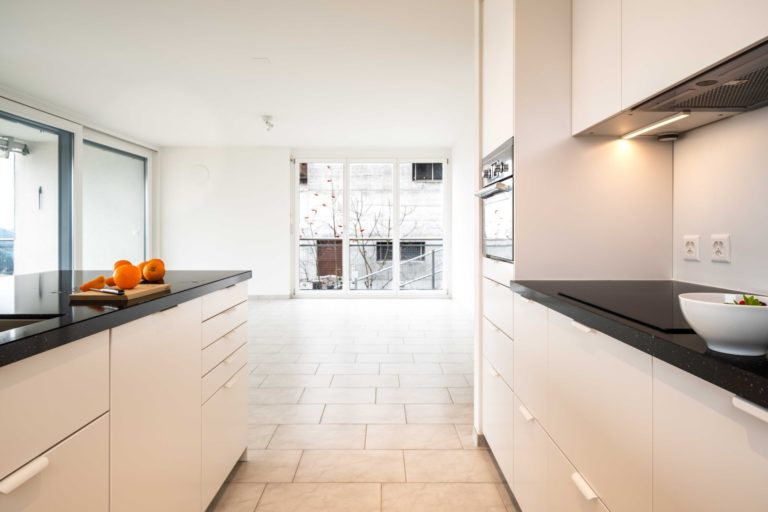 a kitchen with white cabinets