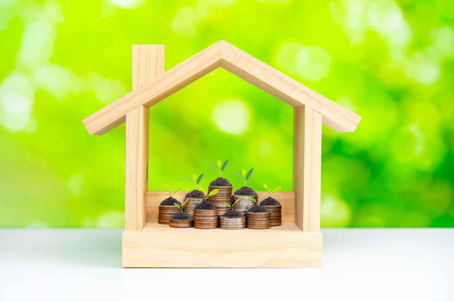 a wooden toy house with coins