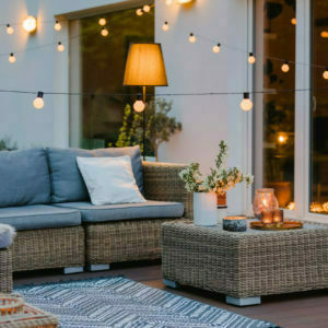 Summer with patio with wicker furniture and lights