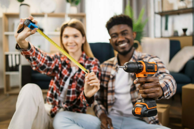 Happy family showing household tools at new house